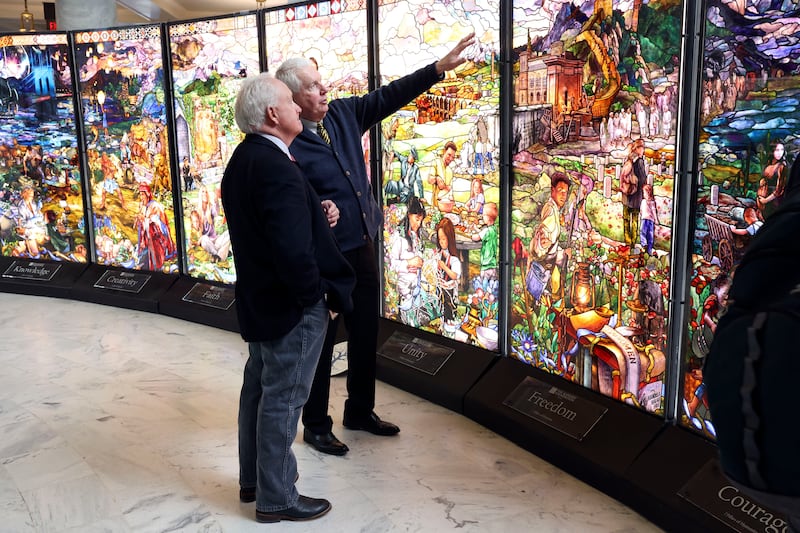 Alan Knight, Roots of Humanity managing director, right, shows Rep. Steven Lund, R-Manti, left, “7 Pillars of Humanity” at the Capitol in Salt Lake City on Tuesday, Feb. 1, 2022. The stained-glass panels were designed and created by Tom Holdman, along with other artists and historians, for the Roots of Humanity Foundation.