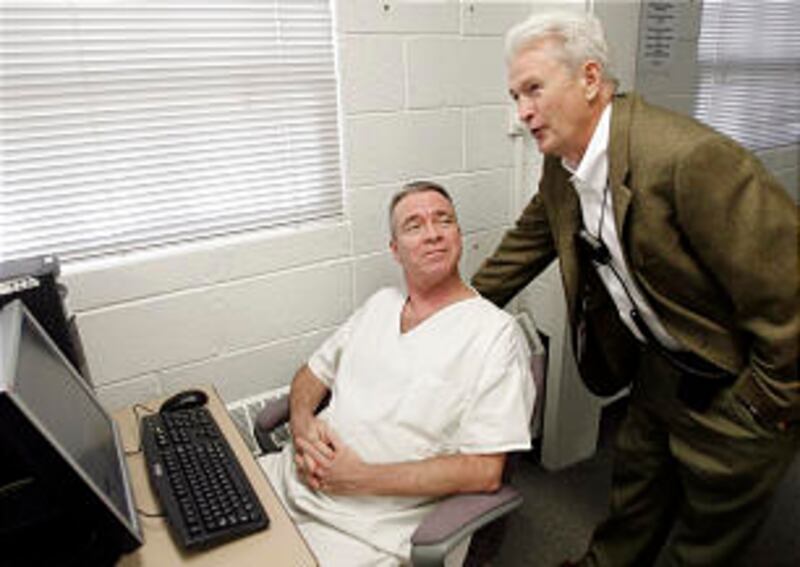 Director Edward Lund talks with inmate Charles Walters at the Family history Center at the Utah Sta