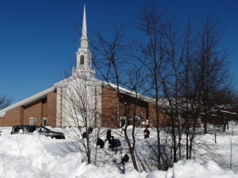 Members of the Centreville Second Ward teachers quorum shovel the stake center sidewalks.