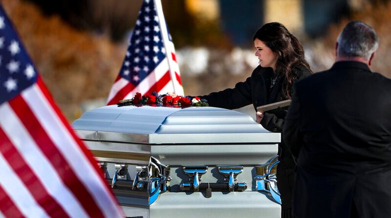 McKenzie Norman Fuchigami, wife of Chief Warrant Officer 2 Kirk T. Fuchigami Jr., rests her hand on her husband’s casket during graveside services at the Brigham City Cemetery on Monday, Dec. 9, 2019. Fuchigami and his co-pilot died when their helicopter crashed as they provided security for troops on the ground in Logar Province in eastern Afghanistan.
