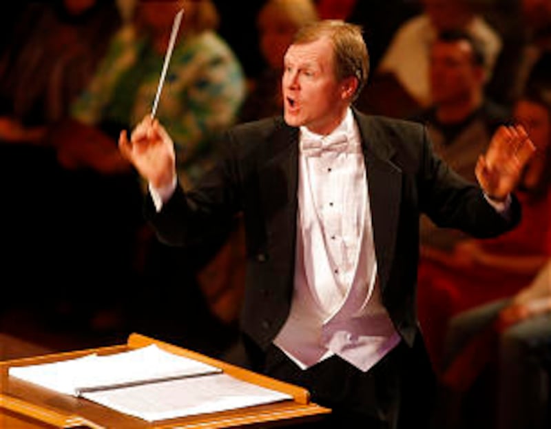 Conductor Randall Kempton guides the choir and orchestra during the concert. A combined student choi