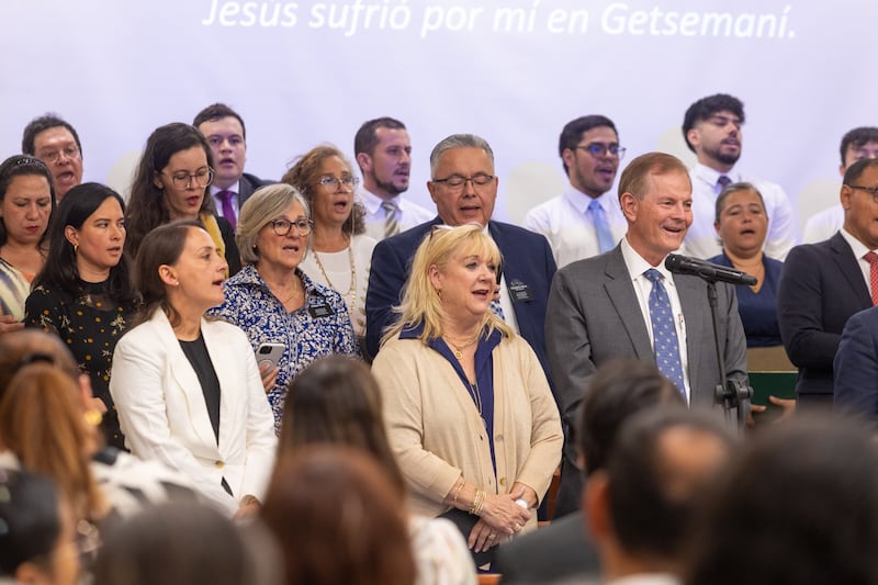 Elder Gary E. Stevenson of the Quorum of the Twelve Apostles and his wife, Sister Lesa Stevenson, sing during a devotional with Latter-day Saints in Cali, Colombia, on Monday, Aug. 24, 2026.