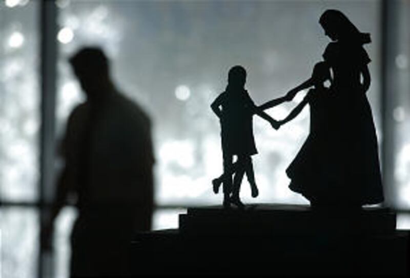 A statue and a man listening to the first Sunday session of the LDS General Conference at the Confer