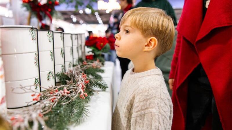 A child waits for a warm cup of Kinderpunsch — a traditional spiced fruit punch — during the opening of the Giving Machine kiosks in Vienna, Austria, on Nov. 13, 2025.