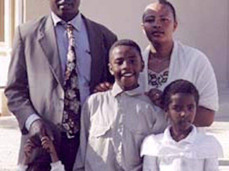 Megenagna Branch President Patrick Onedo, with his wife, Hiwot, and their children, stand in front o