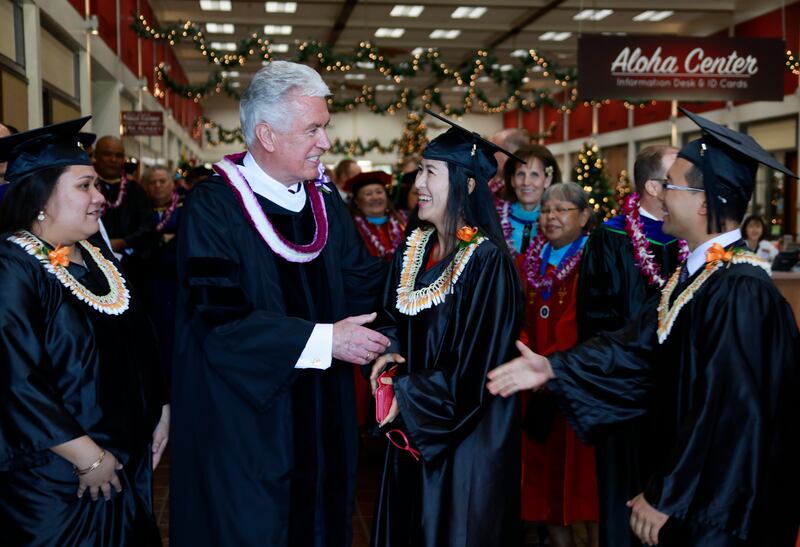 Elder Dieter F. Uchtdorf of the Quorum of the Twelve Apostles greets BYU-Hawaii graduates after giving the commencement address on Dec. 14.