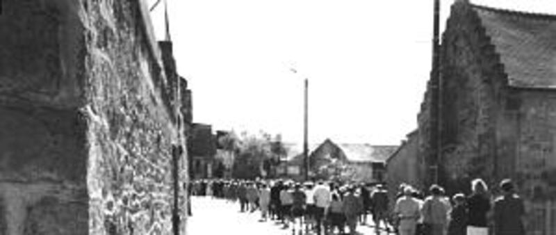French villagers and families of victims on day of monument ceremony 57 years later.