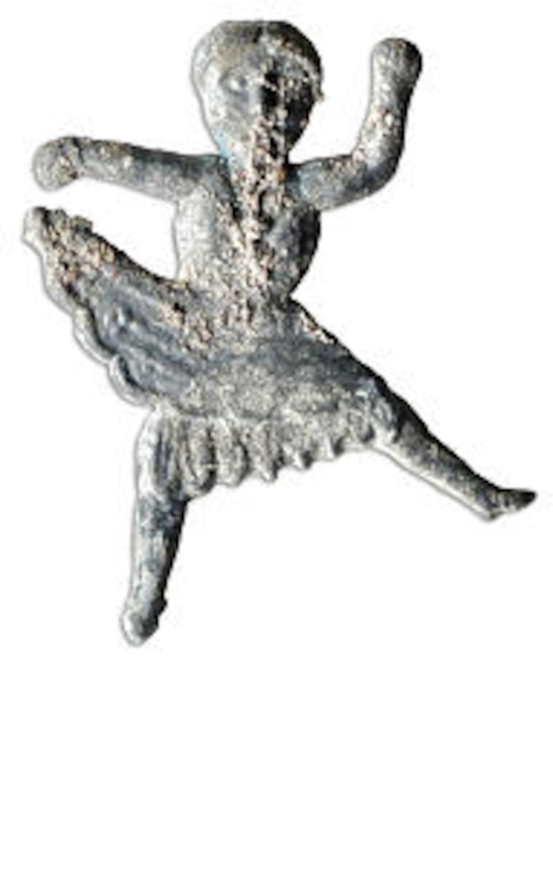 This ballerina was probably used as a small pin or charm.