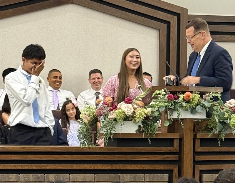 Jose Coy, 18, and Loreana Arguedas, 16, stand with Elder Clark G. Gilbert of the Quorum of the Twelve Apostles at the Schaumburg Illinois Stake Center in Chicago, Illinois on Sunday, Sept. 20, 2026.