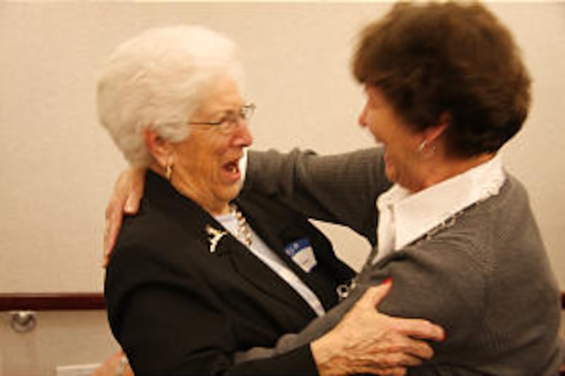 Reba Carn, 91, left, greets President Thomas S. Monson's sister, Marilyn Martin, at reunion of Sixt