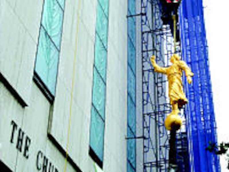Statue of Angel Moroni begins journey to the top of the Manhattan New York Temple. The temple was de
