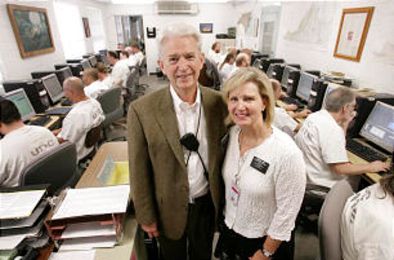 Elder Edward and Sister Penney Lunt supervise inmates at the South Point Family History Center at th
