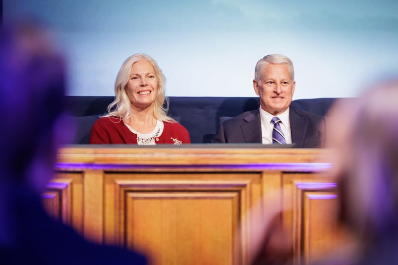 Elder John A. McCune, a General Authority Seventy, and his wife, Sister Debbra McCune, sit on the stand in the Marriott Center in Provo, Utah, prior to BYU's devotional on Tuesday, Dec. 9, 2025.