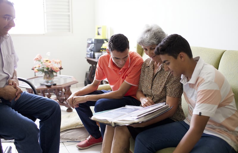 A family in Brazil looks through a photo album.
