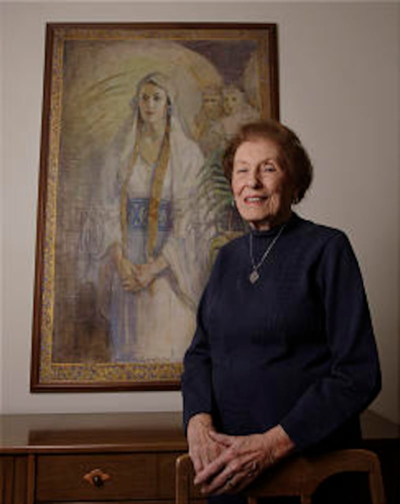 Betty Stokes stands by a painting at her home in Salt Lake City Wednesday, Oct. 19, 2011. Minerva T