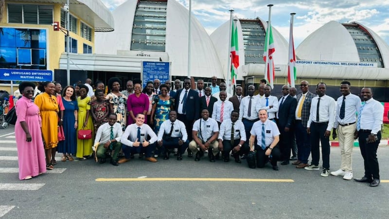 Church members take a picture with missionaries at the airport in Bujumbura, Burundi, on April 16, 2026.