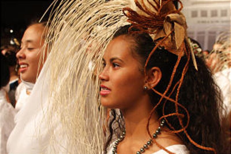 A young performer sheds tears while singing "Aloha Oe" at the end of the cultural program.
