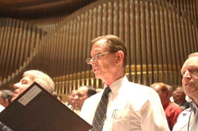 Elder Craig A. Cardon stands and sings with the Mormon Tabernacle Choir during a sound check prior t