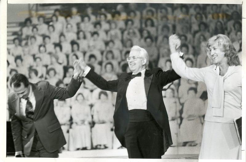 Lin de Paula, left, Wany Santos Thrikill, right, are choir members from Brazil. Jerold D. Ottley, director, presents them to audience during The Tabernacle Choir at Temple Square's concerts in São Paulo, Brazil, in May 1981.