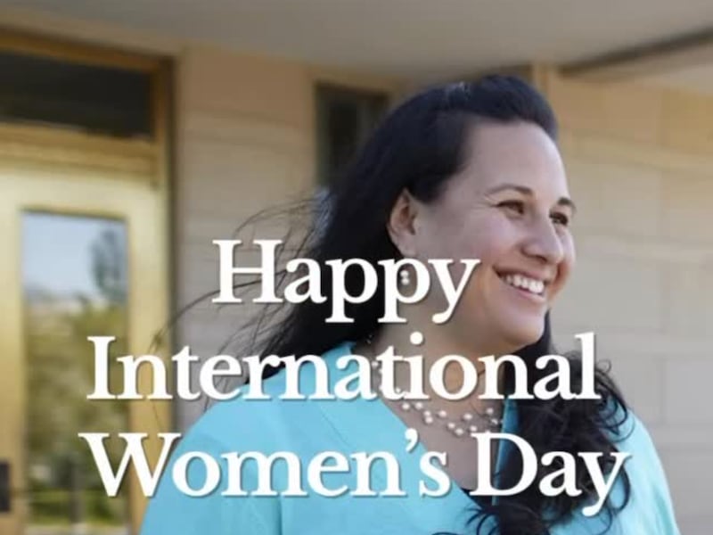 A woman smiles with the words Happy International Women's Day on the picture in this screenshot on Sunday, March 8, 2026.