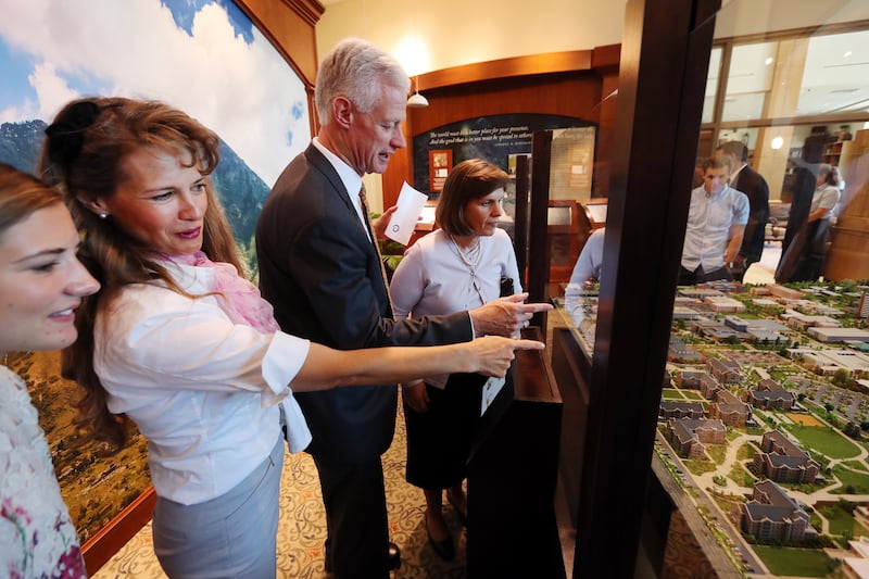 Mary Sorensen, her mother Stephanie Sorensen, President Kevin J Worthen and his wife Peggy look at the Easter egg placed on the map as BYU unveils a highly-detailed campus diorama on Tuesday, July 2, 2019.