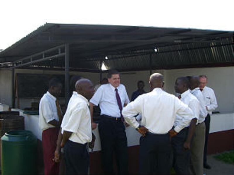 Young Men General President David L. Beck speaks with some local members during his visit.