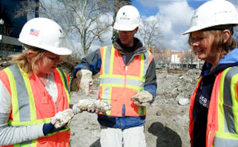 From left, Katie Richards, Scott Ure and Historic Archeologist Deb Harris look at what might be plas