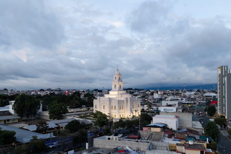 The Miraflores Guatemala City Guatemala Temple illuminated on a cloudy day.