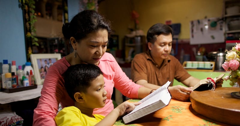 A family in the Philippines studies from the scriptures.