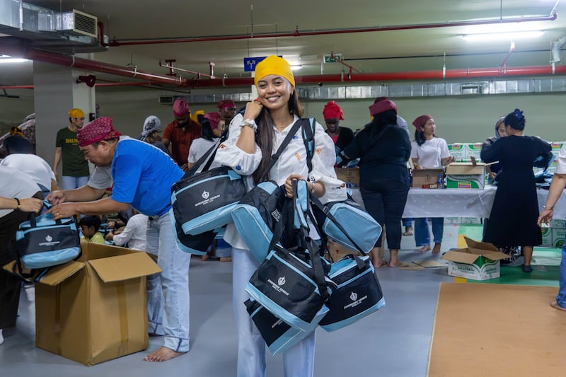 Volunteers from The Church of Jesus Christ of Latter-day Saints assemble food kits during a service project with friends and neighbors of the Sikh community in Dubai, United Arab Emirates, on Friday, Aug. 21, 2026.