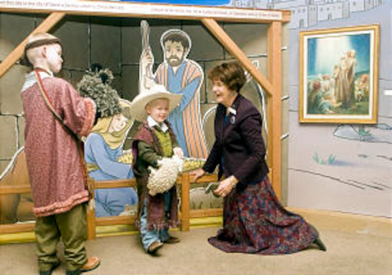 Travis, 9, and Howard Brignone, 4, dress up and get involved with the museum's seasonal nativity sce