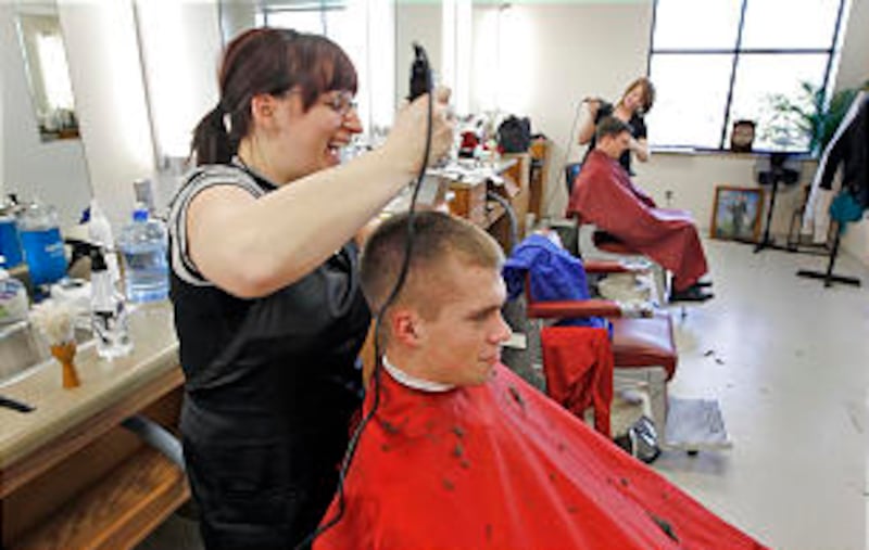 Elder Dylan Coulson, from Grantsville, Utah has his haircut by Melissa Lake in the MTC barbershop.
