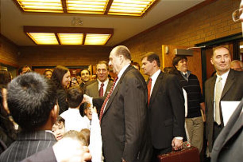 President Thomas S. Monson visits with members after speaking at a sacrament meeting for the Etobic