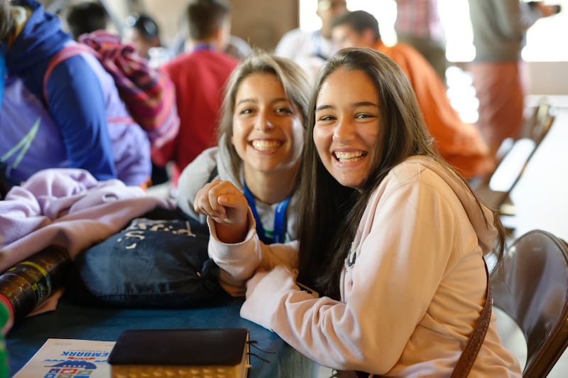 Two young women pose for a photo while attending a FSY conference.