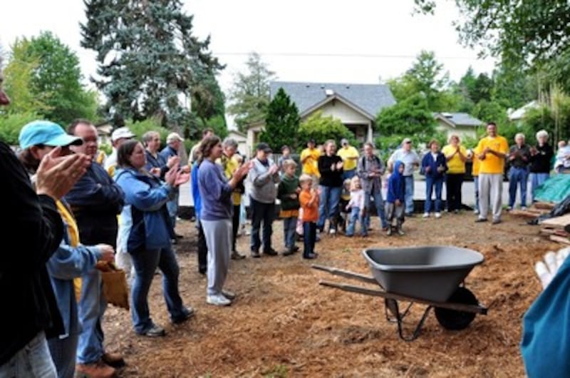 Volunteers applaud the completion of a new park project in Olympia, Washington.