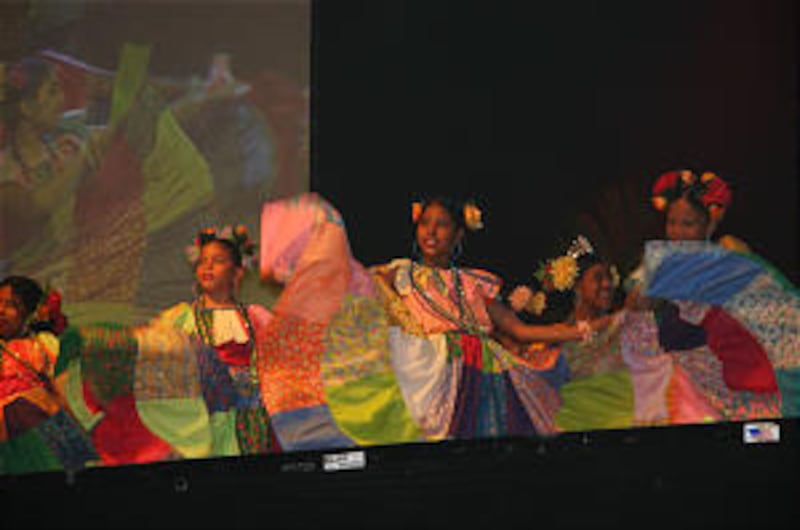 Dancers perform the high-spirited conga. Cultural celebration featured several beloved Latin dances,