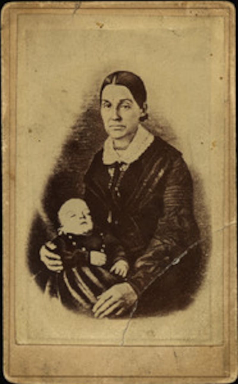 Photograph shows Emma Smith holding her infant son, David Hyrum Smith, who was born after the martyr