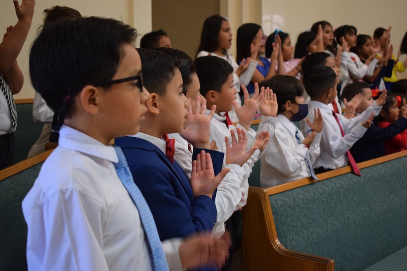 Primary children sing at a Sunday devotional with Elder Dale G. Renlund of the Quorum of the Twelve Apostles in Guatemala in February 2023.