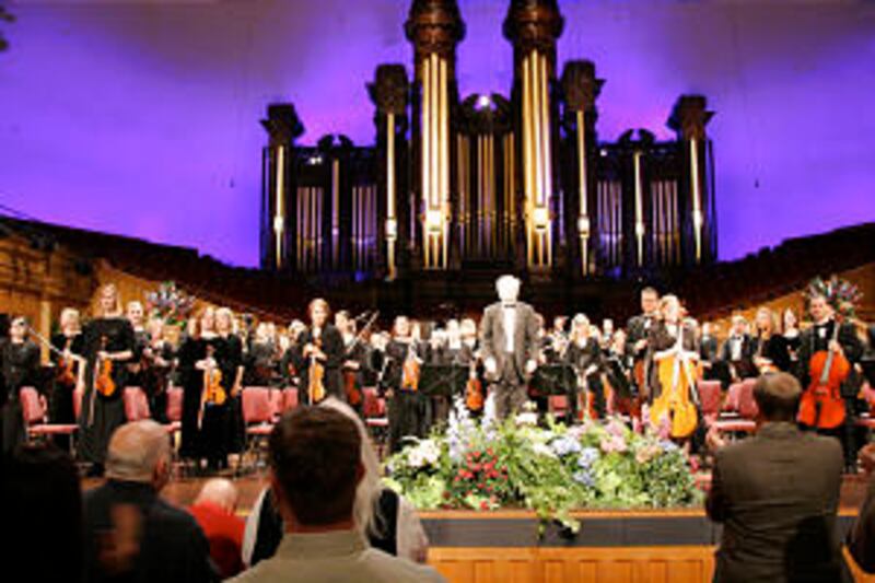 Conductor Igor Gruppman and members of the Orchestra at Temple Square acknowledge a standing ovation