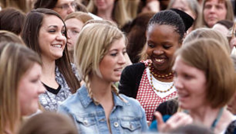 Stephanie Lyon, left, and friend Ayanda Sidzatane, right, from Africa join thousands of young women