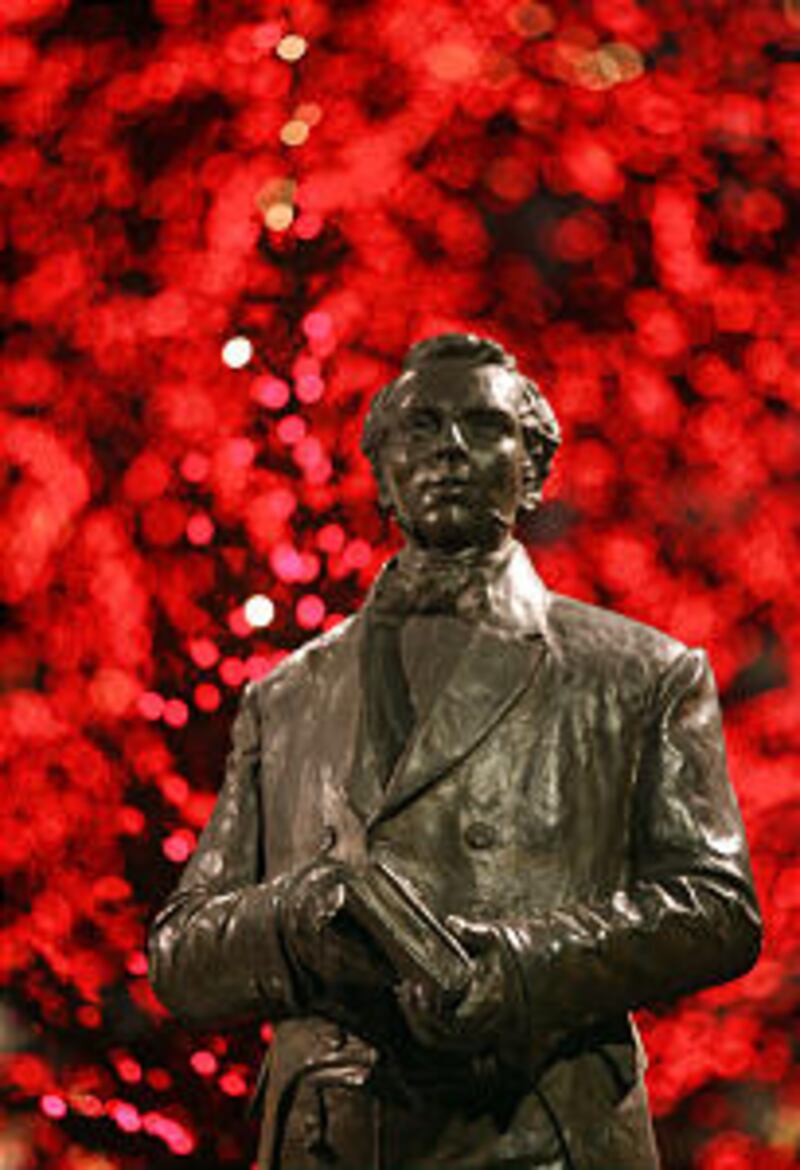A statue of Jospeh Smith is surrounded by Christmas lights on Temple Square after they were turned o
