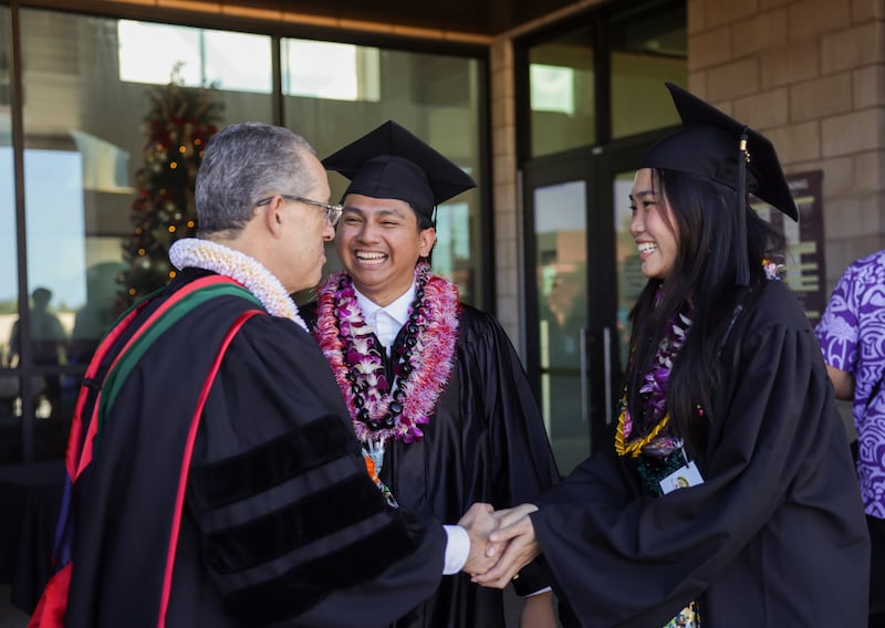 Elder Hugo E. Martinez, a General Authority Seventy, greets BYU–Hawaii graduates following commencement held in the Cannon Activities Center in Laie, Hawaii, on Friday, Dec. 13, 2025.