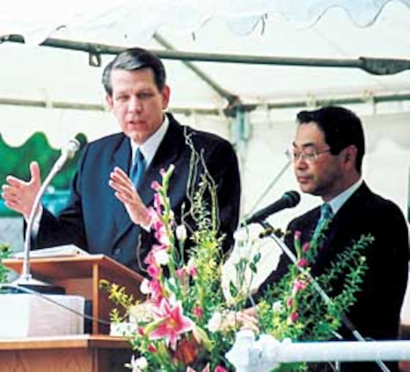 Elder Donald L. Hallstrom of the Seventy speaks during centennial activities, with his remarks trans