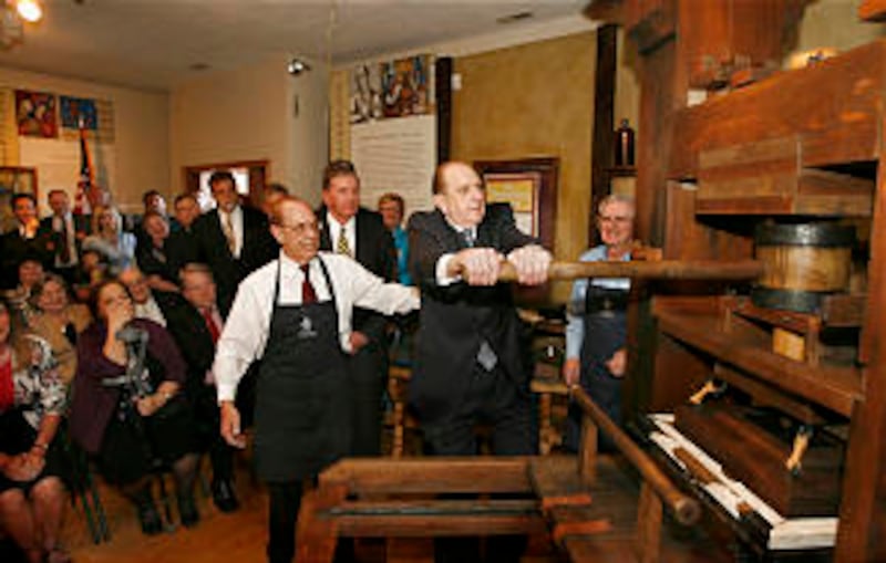 President Thomas S. Monson pulls the "devil's tail" on the replica Gutenberg press in the Crandall H