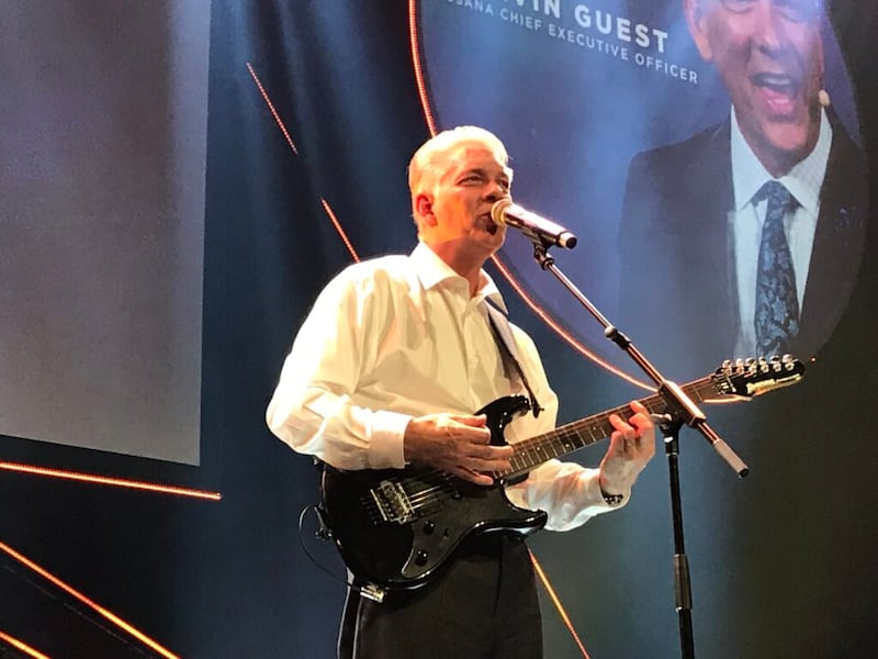 USANA CEO Kevin Guest shares his guitar talents during recent company convention.