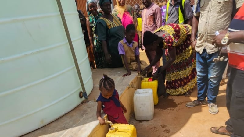 Local residents fill containers with clean water after a handover ceremony in Freetown, western Sierra Leone, on April 3, 2026.