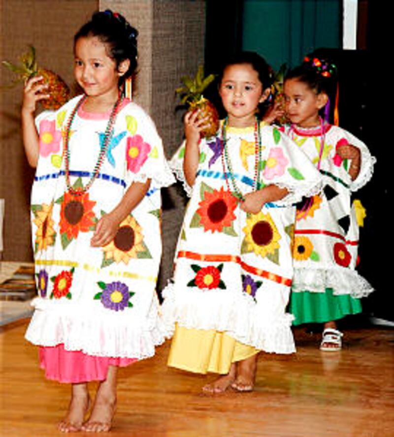 Katherine Romero, Isabelle Castaneda and Jamily Cesar of Peachtree Corners Ward, dance the Flor de