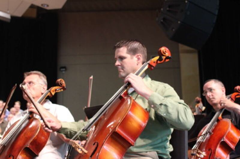 Dave Marsh, left, and Jonny Stewart play bass during rehearsal for a concert by the Tabernacle Choir