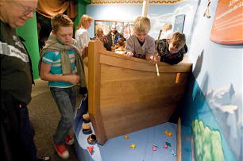 From left, Dawson Burningham, Boston Meacham and Brooks Burningham reel in a fish off the side of a