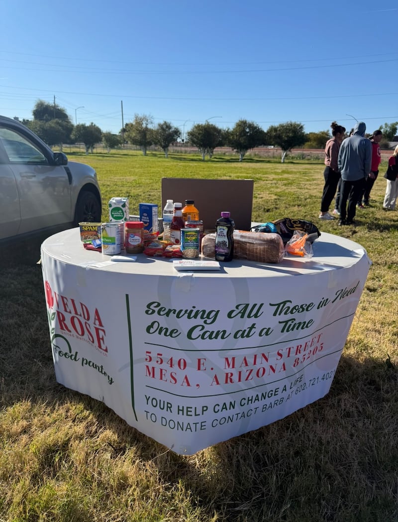 A table with donated food is set up for attendees to contribute additional food donations to the local Methodist food pantry after the second annual Northeast Mesa Grocery Run in Mesa, Arizona, on Feb. 21, 2026.